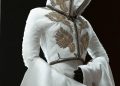 An elegant white garment with gold embroidery.