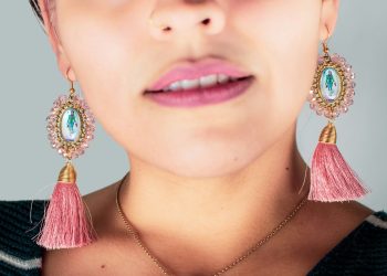 woman wearing silver necklace and earrings