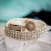 a close up of two rings on a white cloth