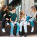 a group of young women sitting on a bench