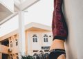 person in black and white nike running shoes and red pants