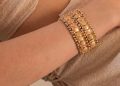 a person wearing a gold bracelet
