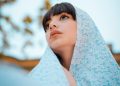 woman in blue scarf and teal shirt