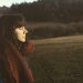 woman close eye standing on grass field