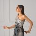 woman in gray one shouldered mini dress
