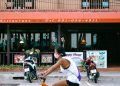 man in white shirt riding on bicycle during daytime