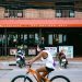 man in white shirt riding on bicycle during daytime